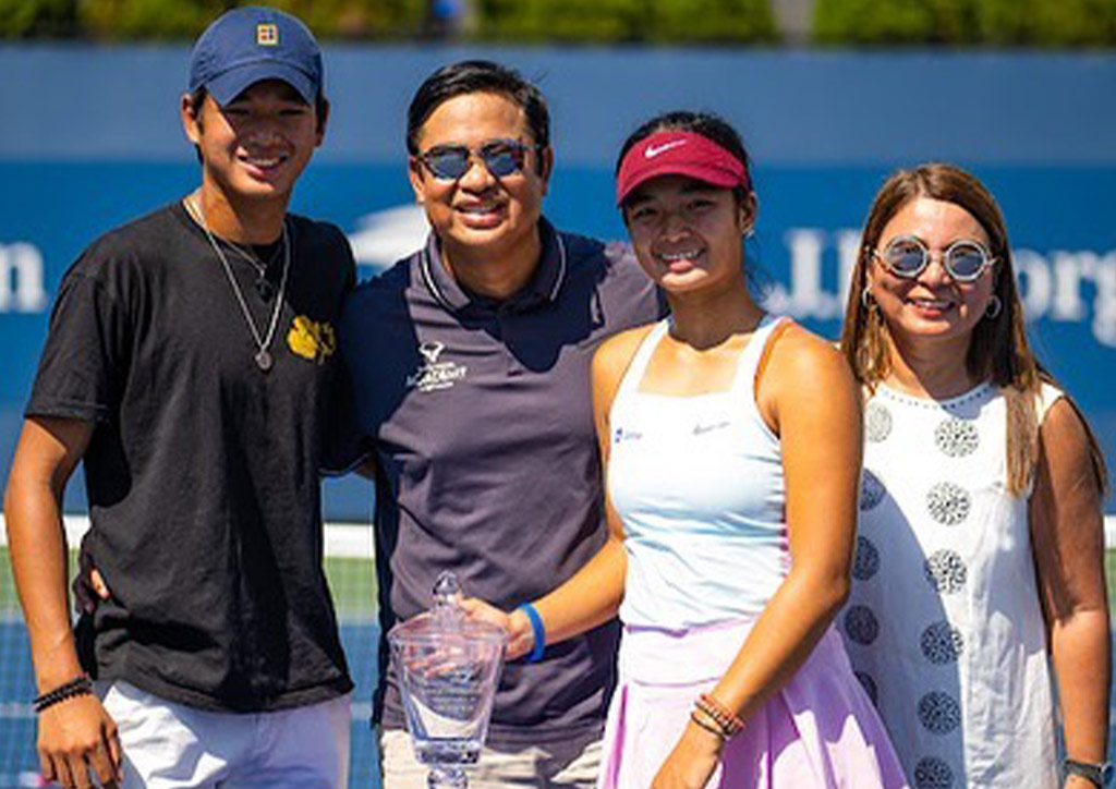 Alex Eala, the first-ever Filipina to win a Grand Slam, celebrates with her parents and brother.